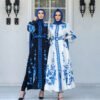 two women wearing dresses and standing in front of a building, abayas online shop