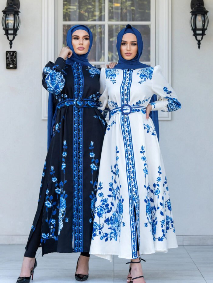 two women wearing dresses and standing in front of a building, abayas online shop