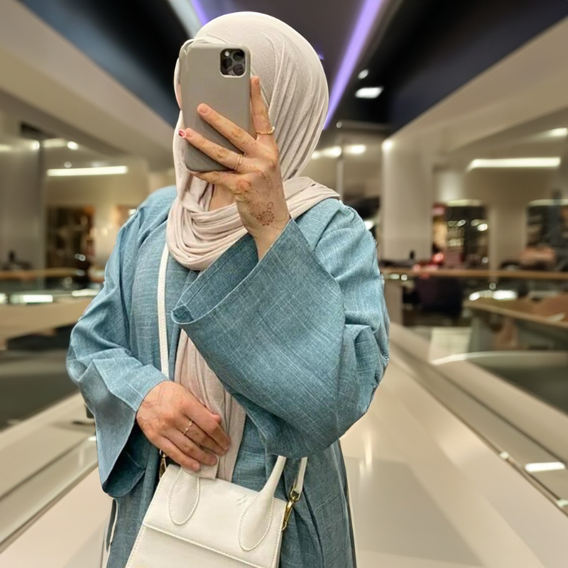 a woman taking a selfie, Wear Abayas