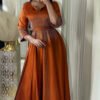 dresses abaya,a woman in an orange dress