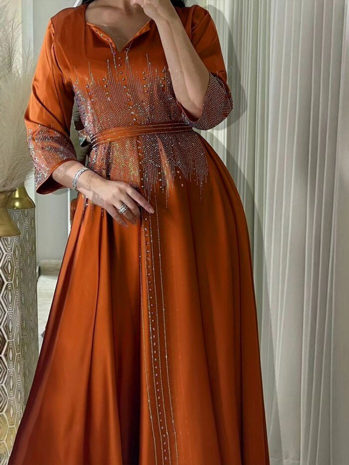 dresses abaya,a woman in an orange dress