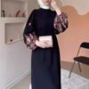 a woman in a black dress,abaya clothing online