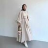 a woman in a dress holding flowers, fashion abaya outfit