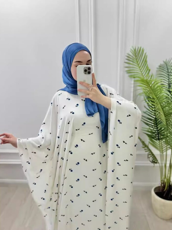 a woman wearing a white dress and blue scarf taking a selfie clothes abaya uk