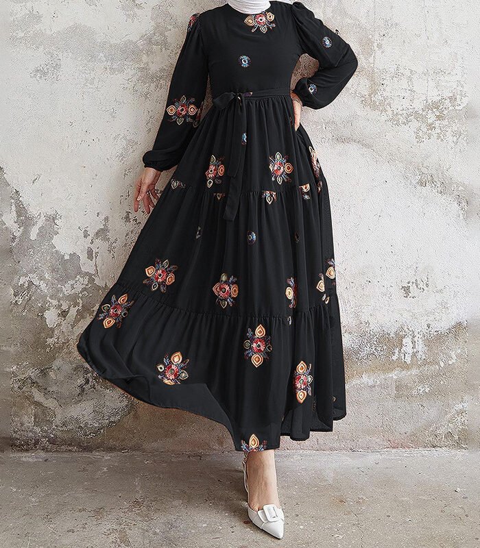 a woman in a black dress abaya style for girl