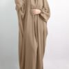 a woman in a brown dress, jilbab