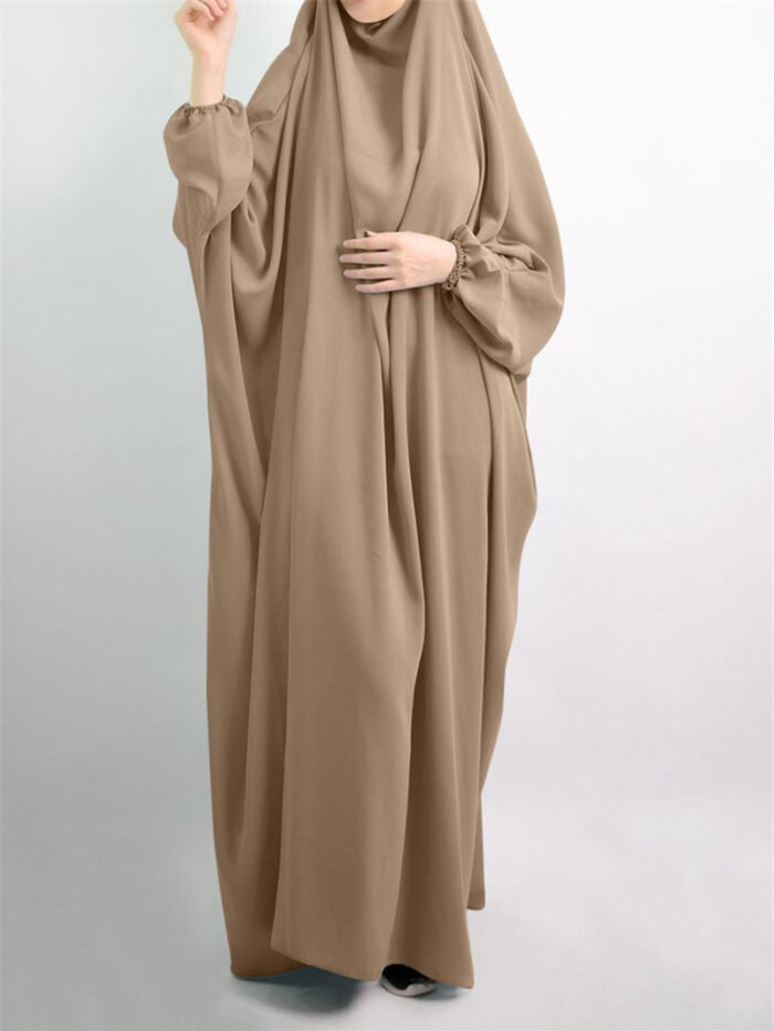 a woman in a brown dress, jilbab