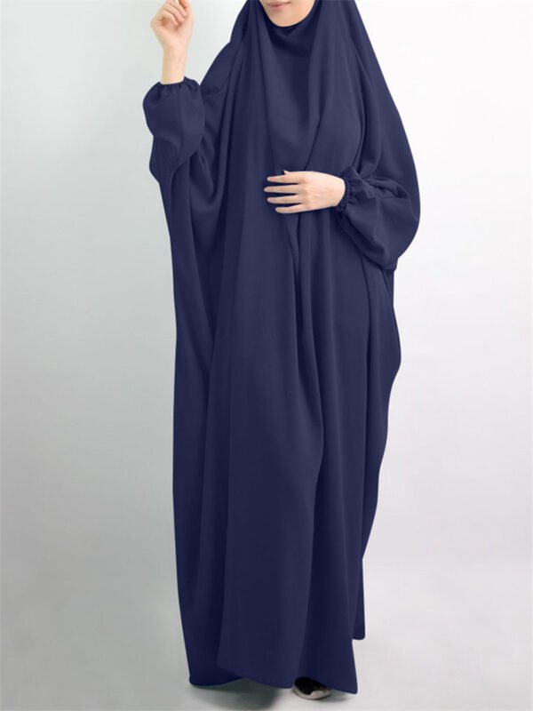 The Cultural Significance of the Jilbab: Understanding Its Role in Modesty and Identity Across Different Societies 3 a woman in a blue dress,
jilbab