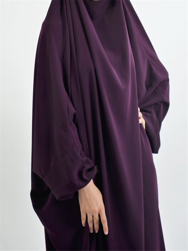 The Cultural Significance of the Jilbab: Understanding Its Role in Modesty and Identity Across Different Societies 2 a woman wearing a purple dress,
jilbab