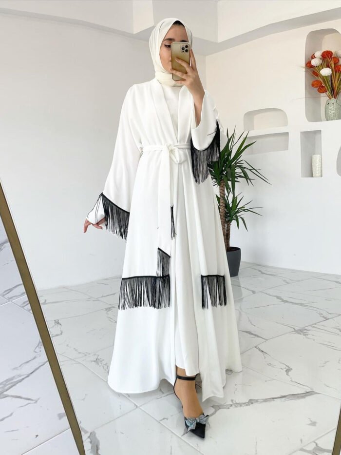 a woman in a white dress taking a selfie in a mirror, turkish abaya online