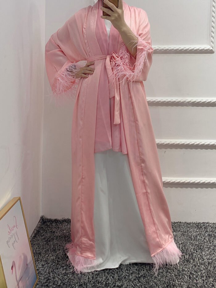 a woman in a robe taking a selfie, fashion and abaya