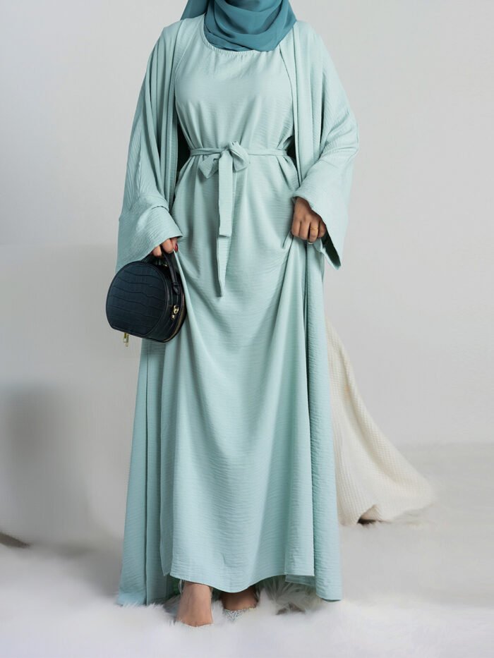 a woman in a blue dress, abaya for sale