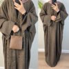 a woman wearing a brown robe,abayas and dresses