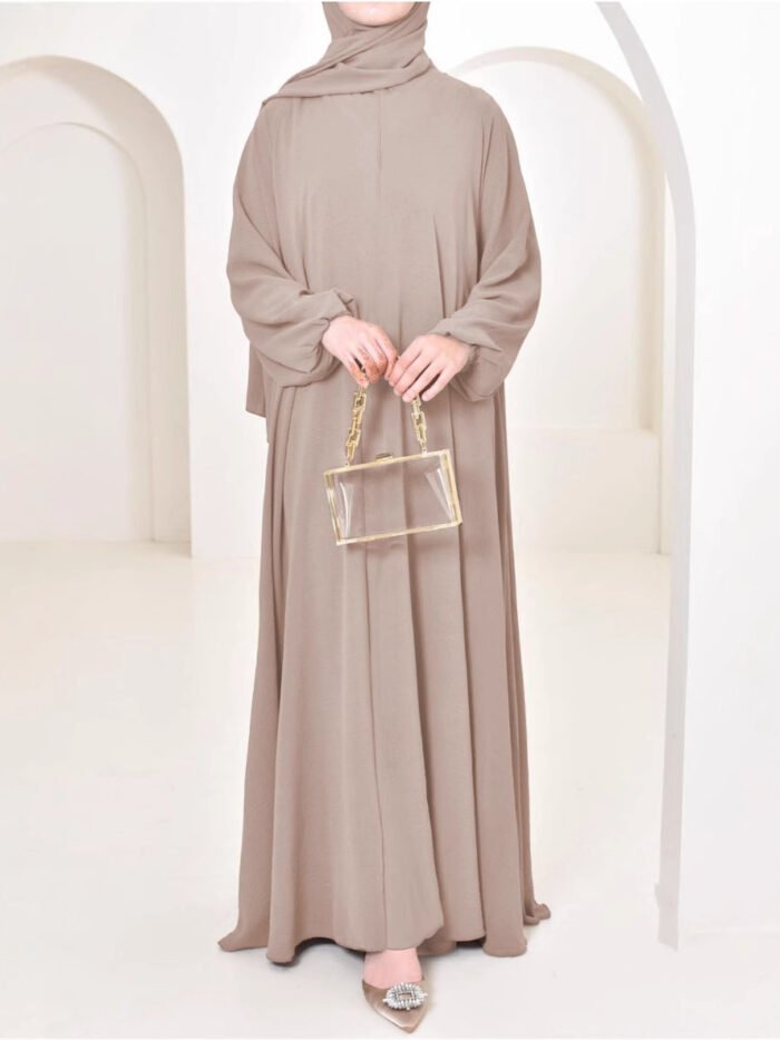 a woman in a long dress, female muslim garment