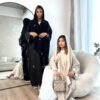 a group of women in black robes, butterfly abaya