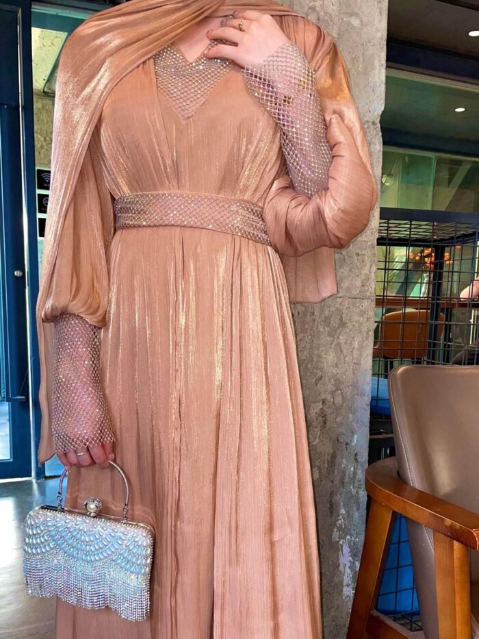 a woman wearing a dress and holding a ,abaya united statespurse