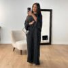 a woman taking a selfie in a room, black fashion abaya