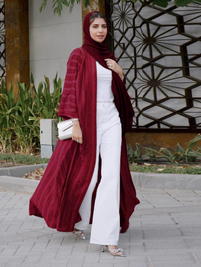 a woman wearing a red scarf and white pants, islamic fashion for women