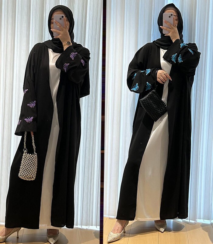 a woman taking a selfie, butterfly abayas