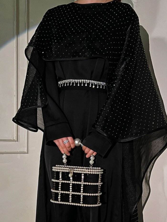 a woman in a black dress,muslim dress
