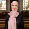 a woman in a pink scarf, headscarf fashion