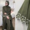 a woman sitting on a couch, islamic clothing for women