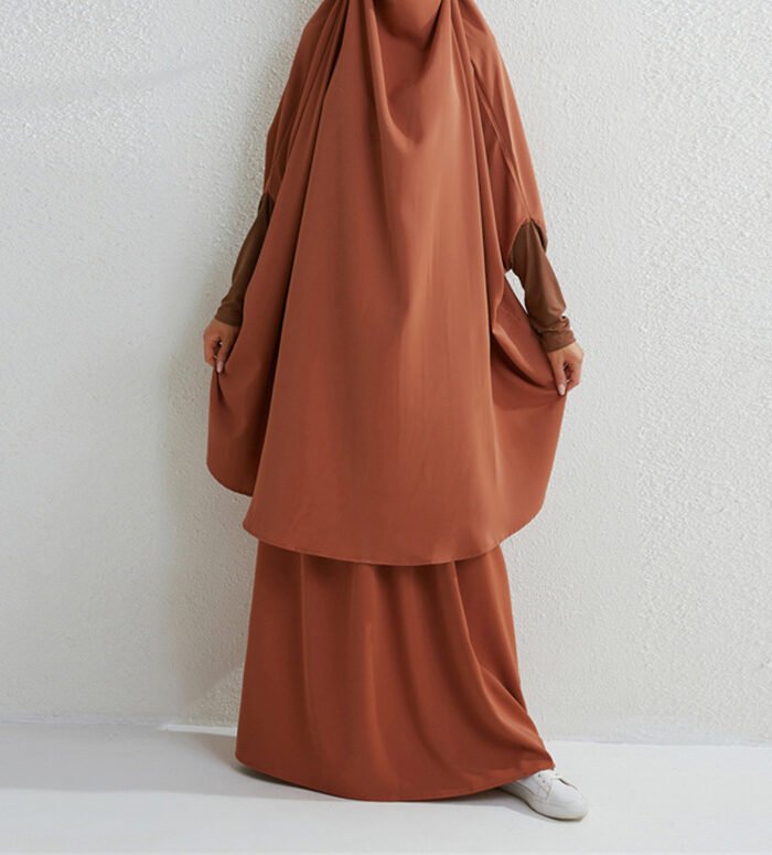 a woman wearing a brown dress, fashionable muslimah